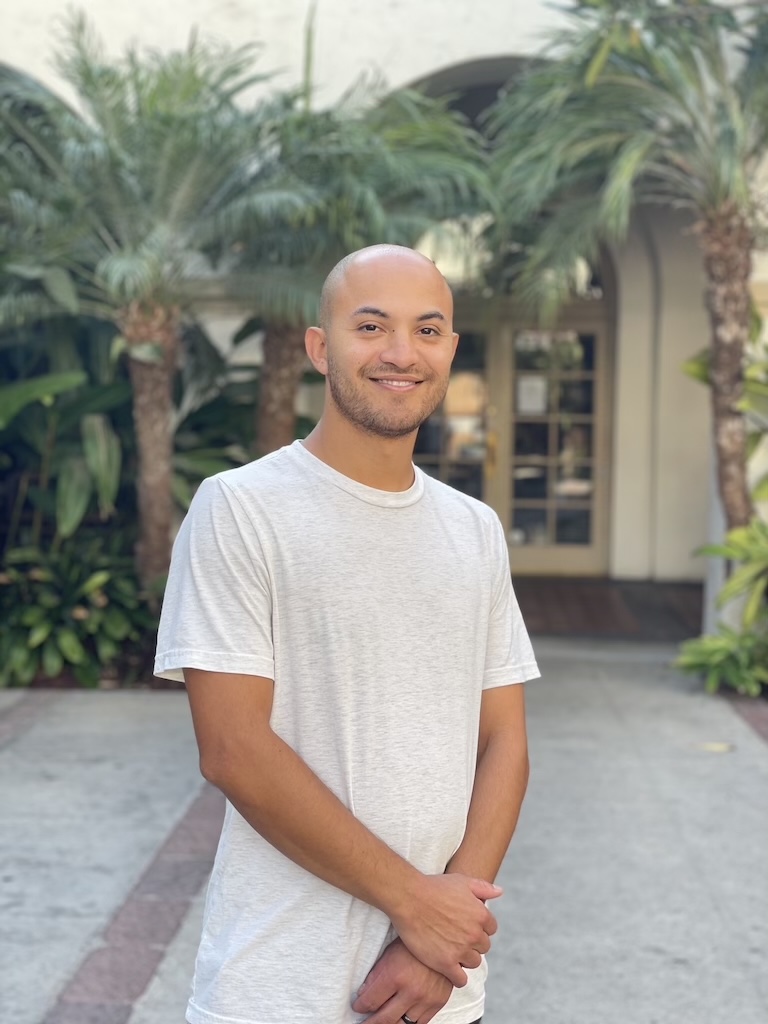 Christian Ventura smiling in a white shirt